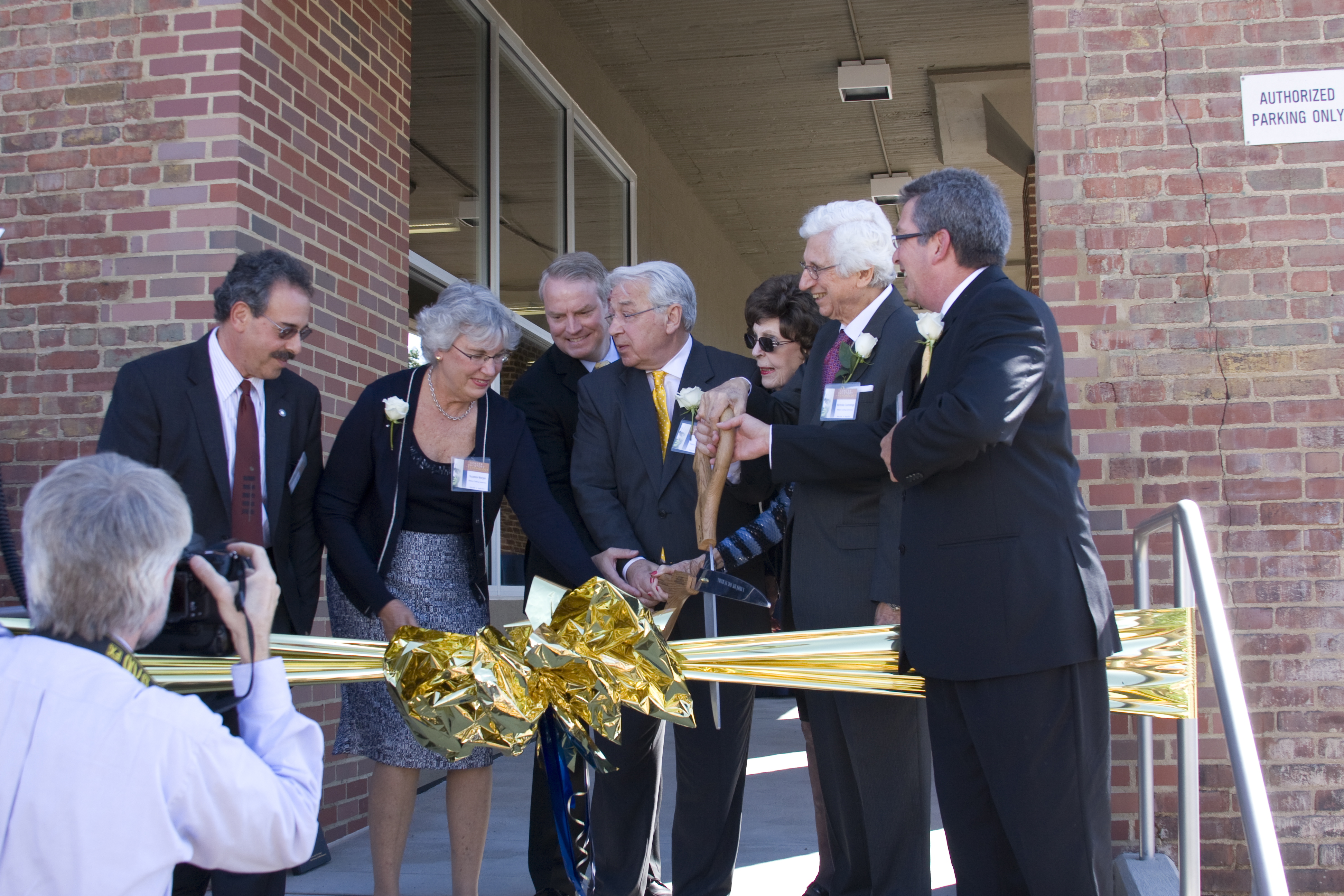 Dr. Baker, Drs. Nicholas Dorothy Cummings and others cutting the ribbon to the museum